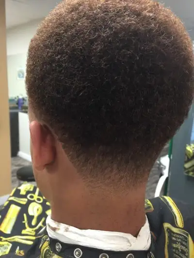 Kids cut with textured curls and a clean taper