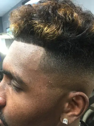 Skin fade with a hard part and textured top